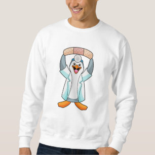 Pinguïn als arts met gips trui