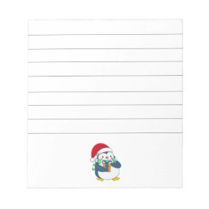 Pinguïn in een kerstpet met cadeau notitieblok