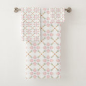 Pink petal and pastel triangle tile pattern on whi bad handdoek (Insitu)