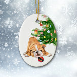 Playful Bulldog Puppy Santa Bulb Christmas Keramisch Ornament<br><div class="desc">On the front of this Christmas ornament is an image of an adorable brown and white Bulldog pup. The puppy has found a Holiday tree bulb that looks like a Santa Claus suit, and is ready to play. The Christmas tree is in the background. The back of the ornament has...</div>