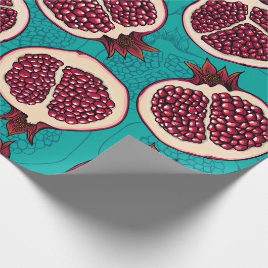 Pomegranaatplakken op turquoise cadeaupapier (Hoek)