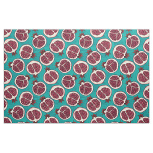 Pomegranaatplakken op turquoise stof