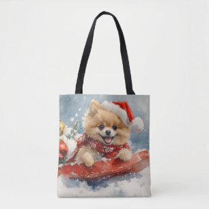 Pomeranian hond in slee laat het sneeuwen Kerstmis Tote Bag