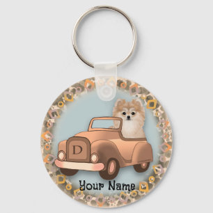 Pomeranian hond rijdt auto sleutelhanger