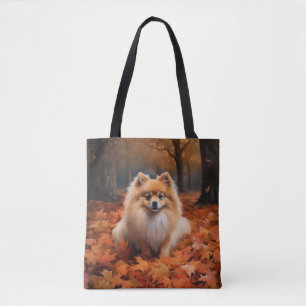 Pomeranian tussen vallende herfstbladeren inspiree tote bag