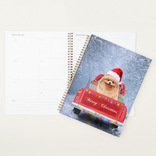 Pommeraanse hond op sneeuw in kerstmis planner (Display)