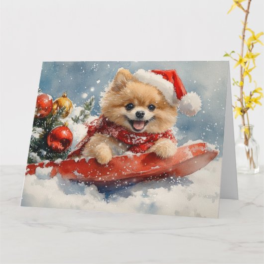 Pommerse Hond in Sledge Laat het Sneeuw Kerstmis Kaart (Gele Bloem)
