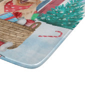 Pommerse hond op sneeuwkerstmis snijplank (Hoek)