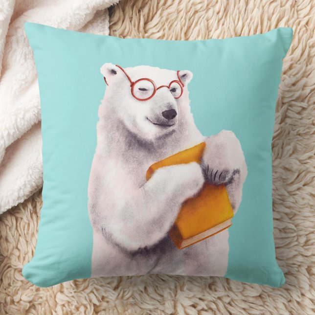 Poolbeer Leest Kunst – Boekliefhebber Kussen (blue pillow with a polar bear with eyeglasses holding a yellow book)
