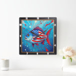 Pop Art Patriotic Fish Vierkante Klok<br><div class="desc">Deze levendige wandklok is voorzien van een unieke pop art stijl vis, gedurfd versierd met de sterren en strepen van de Amerikaanse vlag tegen een dynamische blauwe achtergrond met rode spatten. Dit artistieke uurwerk is een speelse maar patriottische toevoeging aan elk interieur en biedt een kleurrijk en modern statement dat...</div>