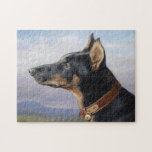 Portrait of a Doberman | Carl Reichert Legpuzzel<br><div class="desc">Portrait eines Dobermanns (1916) | Carl Reichert’s Portrait eines Dobermanns is a striking side-view portrait of a handsome doberman pinscher dog. The painting showcases the dog’s strong, noble profile and sleek fur with remarkable precision, highlighting its elegance and dignified demeanor. Set against a soft, blue sky background, the artwork emphasizes...</div>