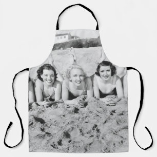 Portret of five young women lying on the beach an schort
