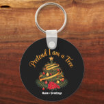 Pretend I Am A Tree Funny Christmas Holiday Sleutelhanger<br><div class="desc">Celebrate the winter season with a touch of irony. This elegant design features a classic decorated Christmas tree with ornaments, ribbons, and a poinsettia, topped with a playful gold script. Ideal for holiday parties and festive gatherings.</div>