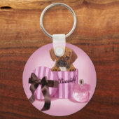 Puggle in een ronde box met staffelkit sleutelhanger (Voorkant)