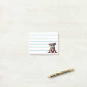 Puppy met blauwe ogen zittend en onschuldig kijken post-it® notes (Op bureau)