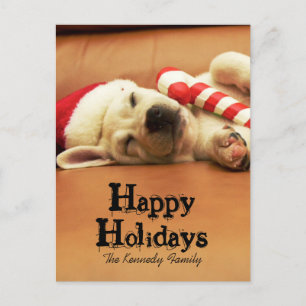 Puppy sleeps on sofa with christmas toys feestdagenkaart