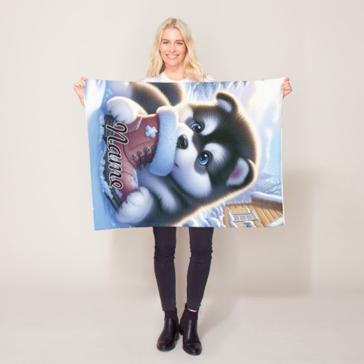 Puppy spelen met een besneeuwde winterschoen fleece deken (In situ)