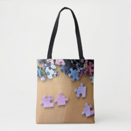 Puzzel stukken op een all over print canvas tas