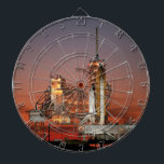 Red Sky voor Space Shuttle Atlantis Lancering Dartbord<br><div class="desc">De frisse ochtendlucht was elektrisch met anticipatie toen de eerste dagen van de dageraad de lucht vurig rood schilderden. Het kolossale witte silhouet van de spaceshuttle Atlantis domineerde het lanceerplatform, slechts overschaduwd door de onmetelijkheid van het moment. Er glipte een gezamelijke zucht door de menigte toen er vuurpluimen uit de...</div>