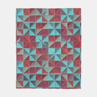 red, teal, purple, and gray quilt fleece deken