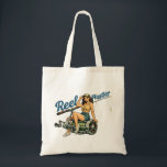 Reel Hustler Retro Fishing Pin-Up | Funny Fish Art Tote Bag<br><div class="desc">Get hooked on this retro inspired Reel Hustler design! Featuring a salty pin-up casually posing on an oversized reel, she's ready to cast lines and catch the big one. Show off your sassy side while repping your favorite hobby with this humorous fish tale tote. This graphic print tote bag is...</div>