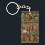 Retro book lover art sleutelhanger<br><div class="desc">A cozy retro-inspired design featuring a charming bookshelf filled with vintage books,  delicate botanical accents,   and a comforting cup of tea or coffee.</div>