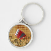 Rode accordeon, zwarte noten, gouden achtergrondke sleutelhanger (Voorkant)