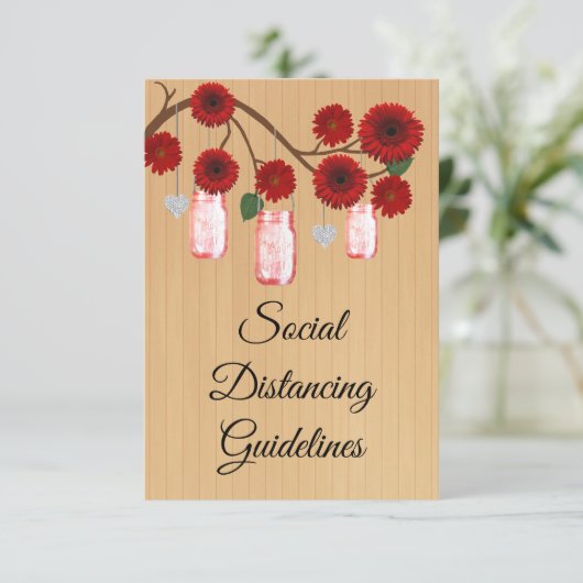 Rode bloemschikking in landelijke stijl in een wec informatiekaartje (Staand voorkant)