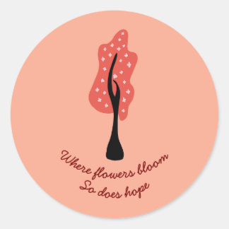 Rode boom in bloei met roze bloemen en citaat ronde sticker