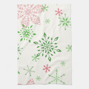 Rode en groene sneeuwvlokken op een witte achtergr theedoek