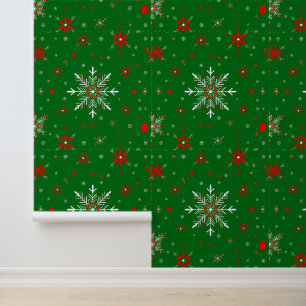 Rode en witte sneeuwvlokken op groen behang
