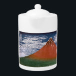 Rode Fuji, ook bekend als Fujiyama vulkaan Katsush Theepot<br><div class="desc">De scene die is vastgelegd in de Japanse blokdruk "Fine Wind, Clear Morning" (ook bekend als "Red Fuji" of "Aka Fuji"), is een adembenemende show van de berg Fuji, gebaad in de levendige tinten van zonsopgang. Dit kunstwerk maakt deel uit van de beroemde serie van Katsushika Hokusai, "36 Uitzichten van...</div>