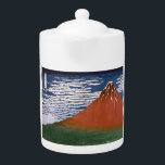 Rode Fuji, ook bekend als Fujiyama vulkaan Katsush Theepot<br><div class="desc">De scene die is vastgelegd in de Japanse blokdruk "Fine Wind, Clear Morning" (ook bekend als "Red Fuji" of "Aka Fuji"), is een adembenemende show van de berg Fuji, gebaad in de levendige tinten van zonsopgang. Dit kunstwerk maakt deel uit van de beroemde serie van Katsushika Hokusai, "36 Uitzichten van...</div>