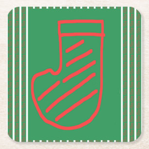 Rode groene kerstsok op groen kartonnen onderzetters
