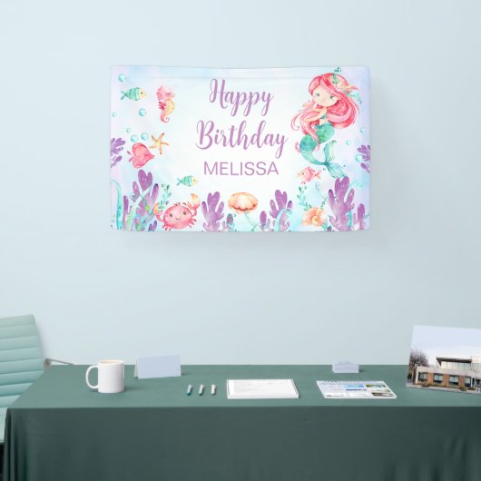 Rode haarzeemeermin onder de achtergrond van de ge spandoek (Beurs)