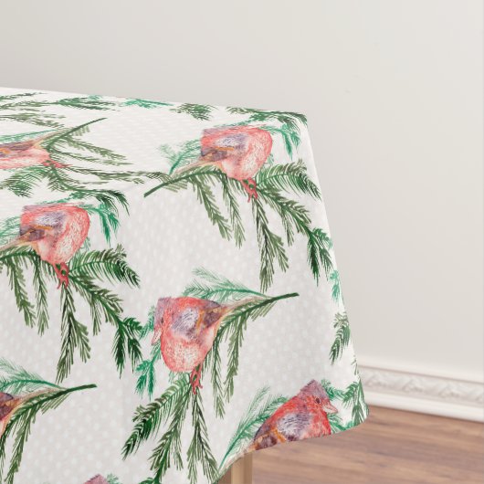 Rode kardinalen op de groene kerst tafelkleed (Voorbeeld)