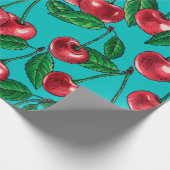 Rode kersen op turquoise cadeaupapier (Hoek)