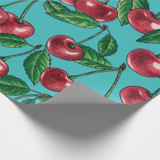 Rode kersen op turquoise cadeaupapier (Hoek)