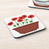 Rode klaprozen in een terracotta plantenbak bier onderzetter (Linkerzijde)