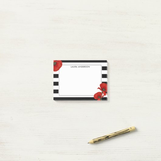 Rode klaprozen op zwarte en witte strepen post-it® notes (Op bureau)