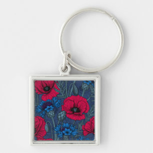 Rode papaver en blauwe cornbloemen op blauw sleutelhanger