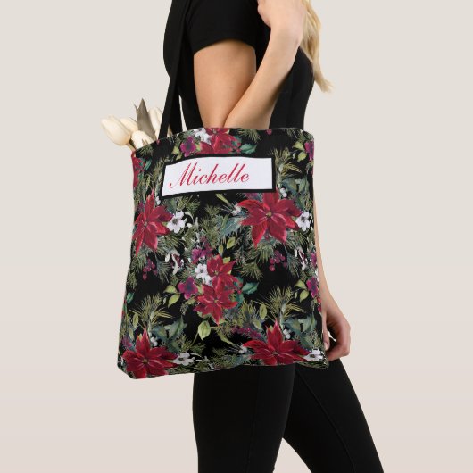 Rode poinsettia's en witte bloemen op zwart tote bag (Dichtbij)