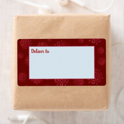 Rode sneeuwvlokken leveren aan verzendlabels etiket (Insitu)