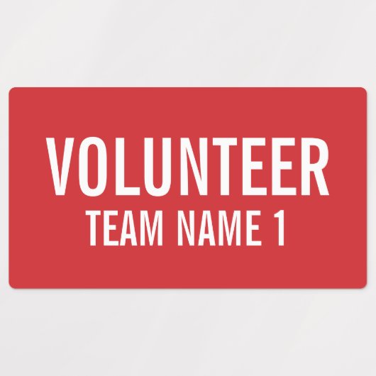 Rode vrijwilligersbadge met de naam van het Team v Labels (Design 1)