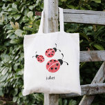 Rode Waterverf Ladybugs gepersonaliseerd Tote Bag<br><div class="desc">Deze canvas tas bevat drie zoete ladybugs in zachte rode en koolzuurhoudende waterverven. Coördineert met ons collectie van Waterverf Ladybug kleding en accessoires. Pas je aan met een naam als je dat wilt — maakt een perfecte feestvreugde voor meisjes's verjaardagsfeestjes!</div>