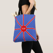 Rode zonnestralen op blauw tote bag (Dichtbij)