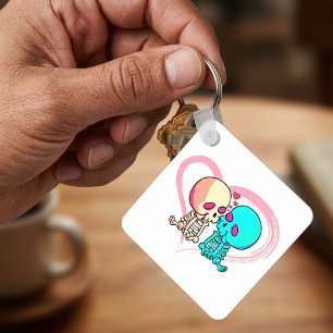 Romantisch geraamte stel dat zoent in roze hart sleutelhanger
