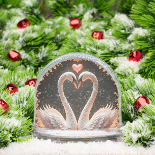 Romantisch paar elegante zwanen te midden van roze sneeuwbol