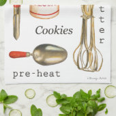 Rood behandeld  keukenbakgereedschap op handdoek. theedoek (Gevouwen)