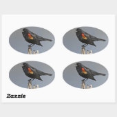 Roodvleugelige zwarte hond ovale sticker (Vel)